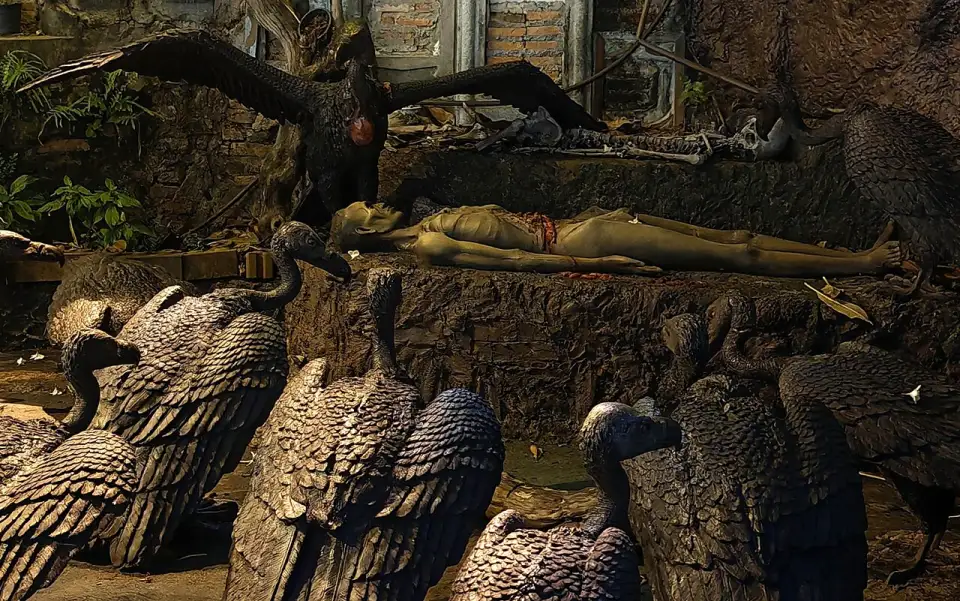 Vulture sculptures beside a lying figure on the way up the Golden Mount