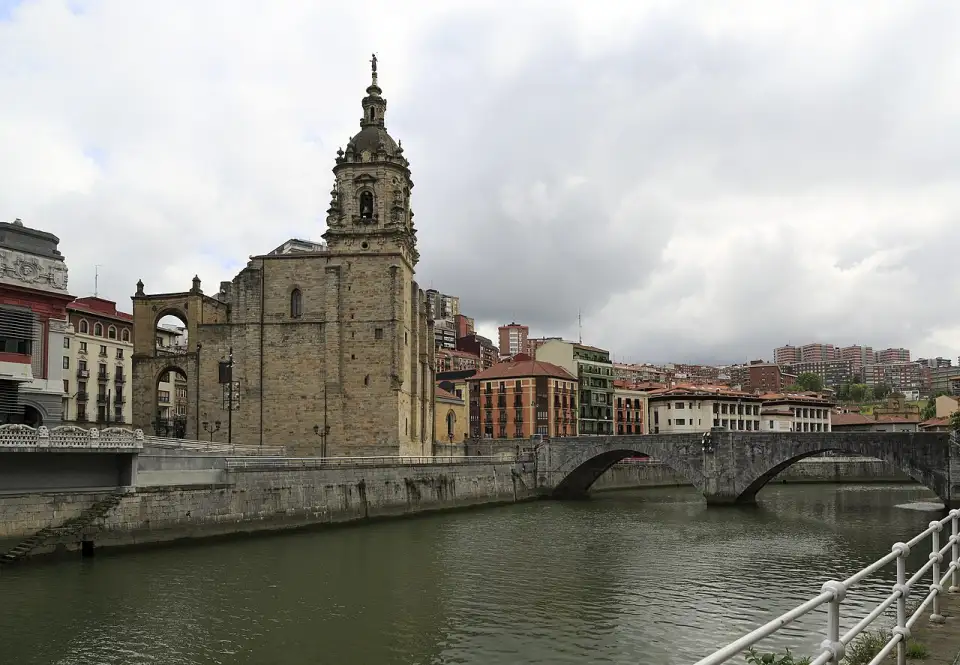 The Gothic church of San Antón with its Baroque tower beside the two-arched stone bridge over the Bilbao estuary