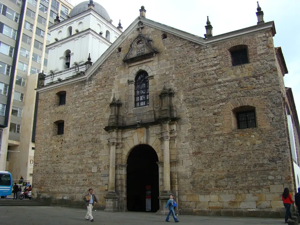 Stone façade of the Church of San Agustín with its white tower