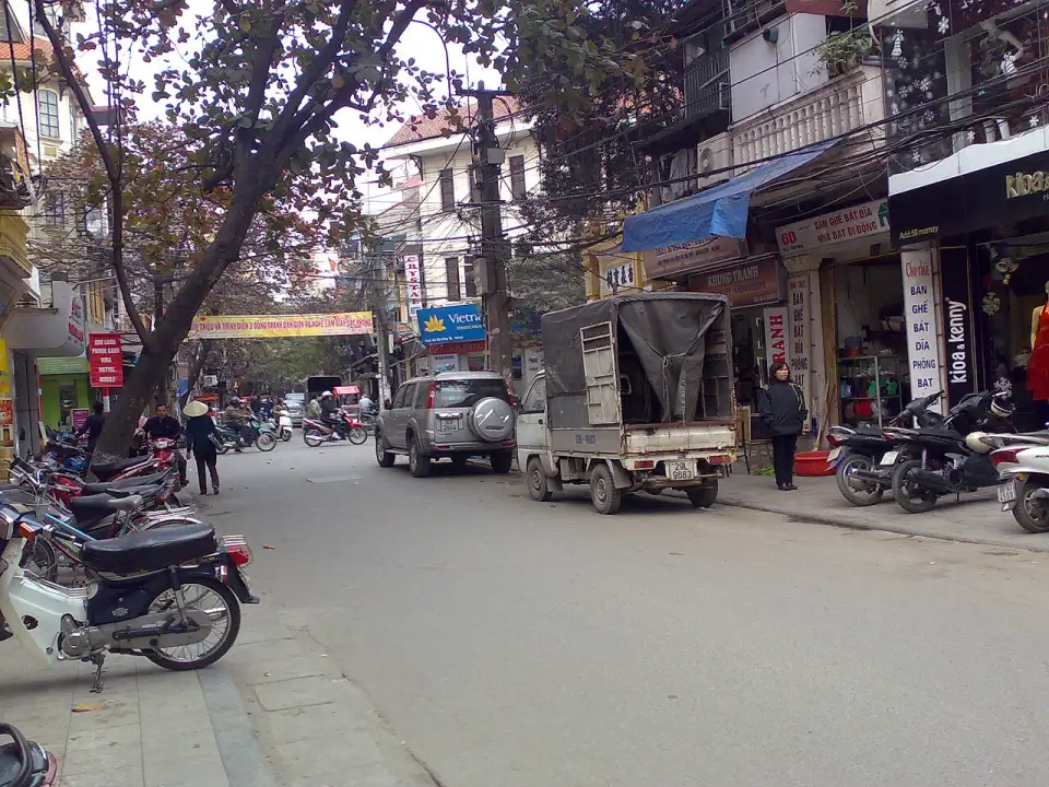 Mã Mây Street in the Old Quarter, with shops and parked motorbikes