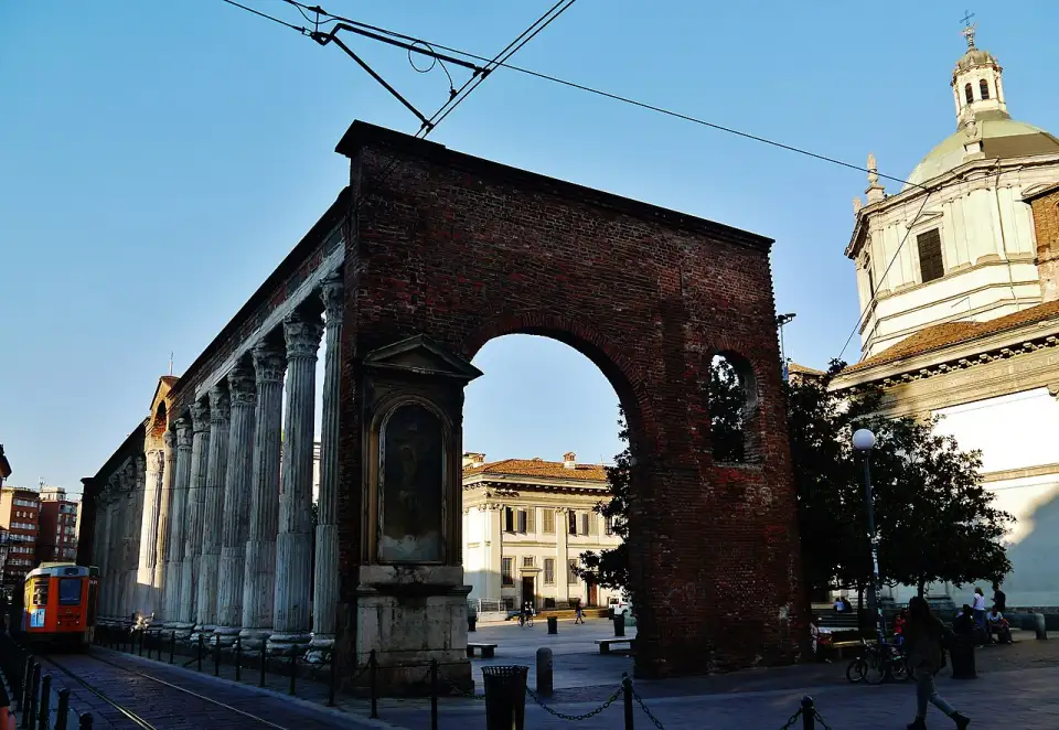 Roman colonnade of San Lorenzo with its brick arch and the basilica dome behind