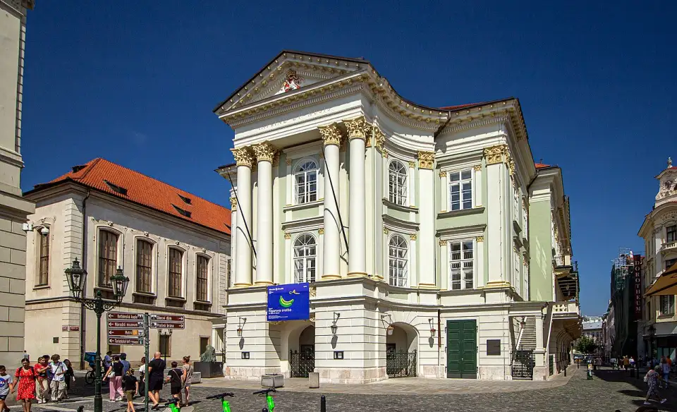 Green and white neoclassical facade of Prague's Estates Theatre
